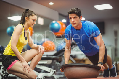 Fit woman working out with trainer