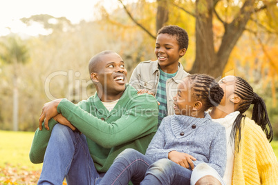 Portrait of a young family sitting in leaves