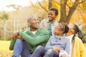 Portrait of a young family sitting in leaves