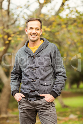 Young handsome man posing in park