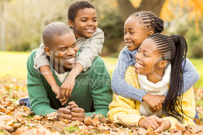 Portrait of a young family lying in leaves