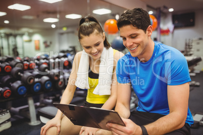 Trainer and client discussing her progress