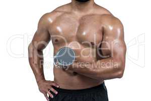 Muscular man lifting heavy dumbbell