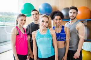 Fitness class smiling at camera in studio