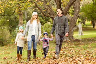 Young family running in leaves