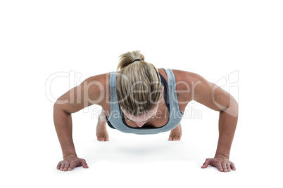 Muscular woman doing push-ups