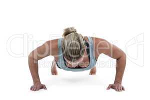 Muscular woman doing push-ups