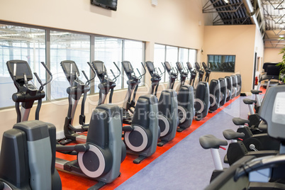 Collection of exercise bikes in a row