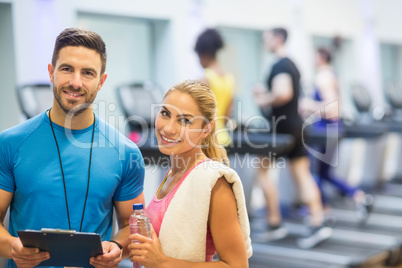 Trainer and client discussing her progress