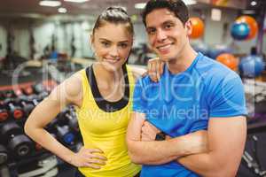 Fit couple smiling at camera