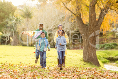 Young family playing with a kite