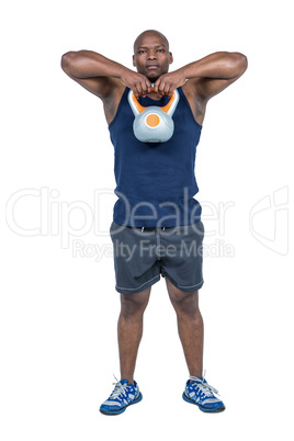 Muscular man exercising with kettlebell