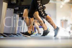 Fit people jogging on treadmills