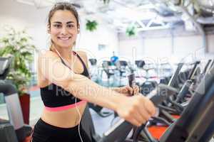 Focused woman on the cross trainer