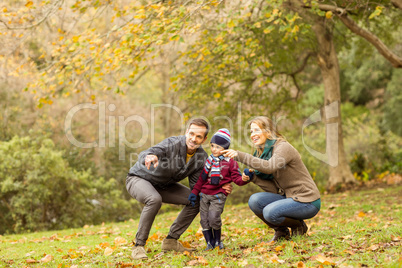 Young couple pointing something to their little boy Young couple pointing something to their little boy