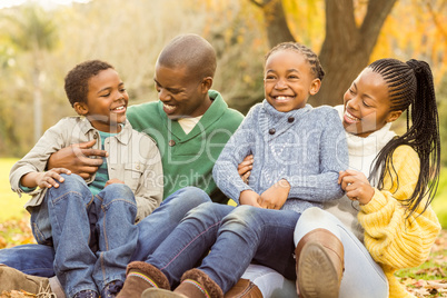 Portrait of a young family sitting in leaves