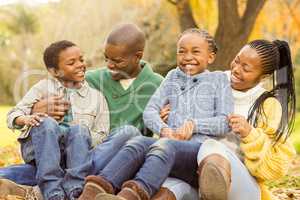 Portrait of a young family sitting in leaves