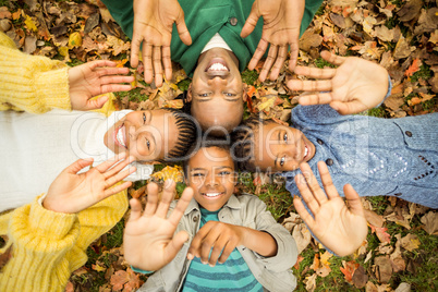 Young family doing a head circles and raising their hands