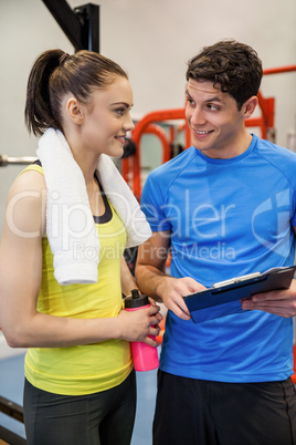 Trainer and woman discussing workout plan