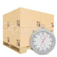 Paper covered boxes on wooden pallet with a stopwatch standing next