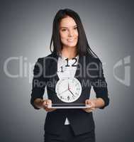 Business woman shows a clock. Flying digits symbolize leaving time