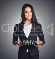 Business woman holding a chess urging to make the right move
