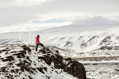 Hiker at mountain top of waterfall Godafoss