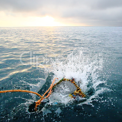 Splashing creel in the sea at dawn