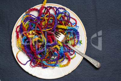 Full plate of melange yarn with a fork