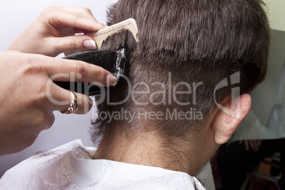 man getting a haircut by a hairdresser.