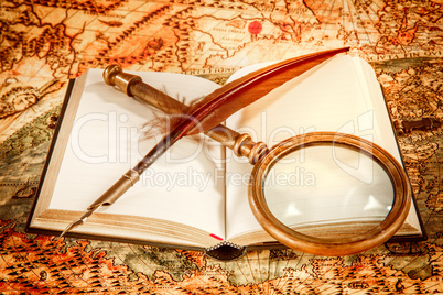 Vintage magnifying glass lies on an ancient world map