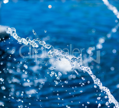 Close-up of suspended water stream and droplets