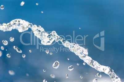 Close-up of water stream falling into focus