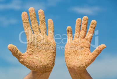 Woman and Man Shows his Open Hands Covered with Beach Sand