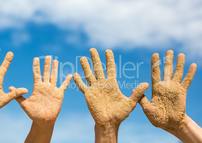 Woman and Man Shows his Open Hands Covered with Beach Sand