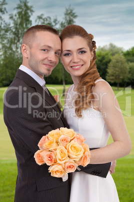 Young wedding couple in the park
