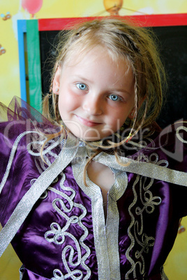 little blue-eyed girl in an Moroccan suit