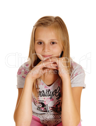 A sad looking young girl sitting on chair.