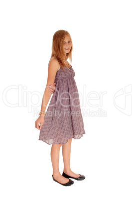 Lovely little girl in dress standing.