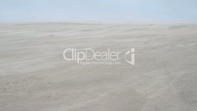 Sand blowing over a sand dune