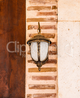 Lamp Hanging On A Brick Wall