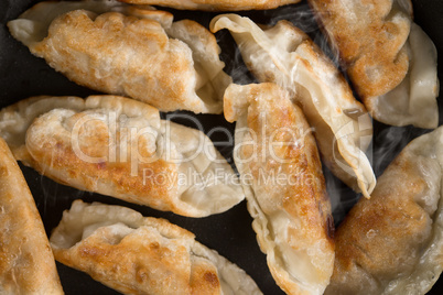 Close up Asian food fried dumpling in cooking pan