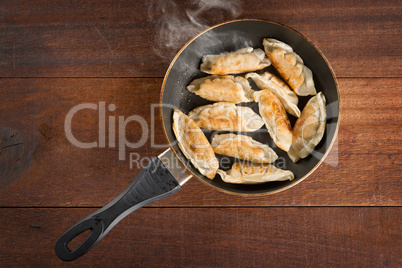 Asian food fried dumpling in cooking pan