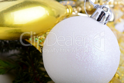 festive golden christmas decoration, candles, white balls, green fir tree branch, close up