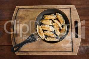 Asian meal fried dumpling in cooking pan