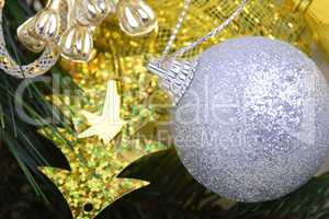 festive golden christmas decoration, candles, white balls, green fir tree branch, close up