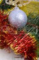 Closeup of Christmas balls and green fir tree branch, new year invitation card