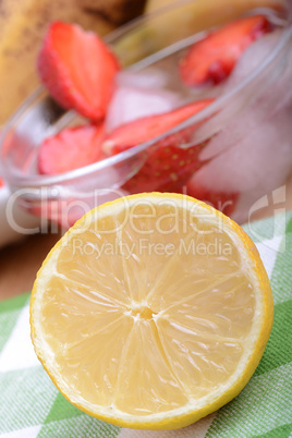 Close up of a cup of sliced strawberries with lemon