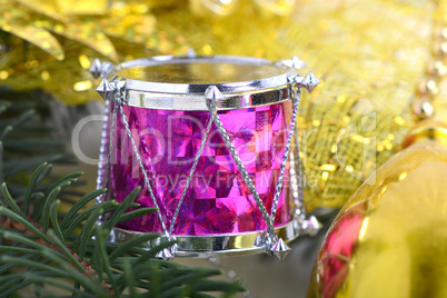 Christmas background with drums, green eve tree branch, golden new year decoration