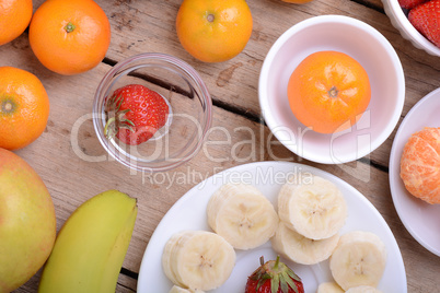 Fresh colorful fruits composition mandarin, strawberry, peach, bananas and orange